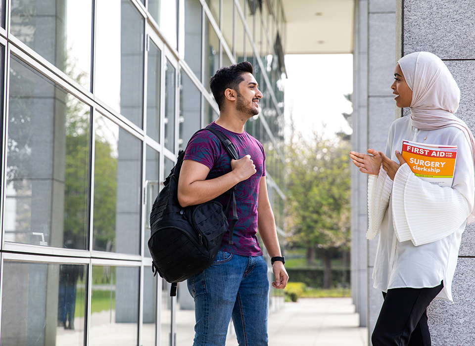 Man and woman talking outside